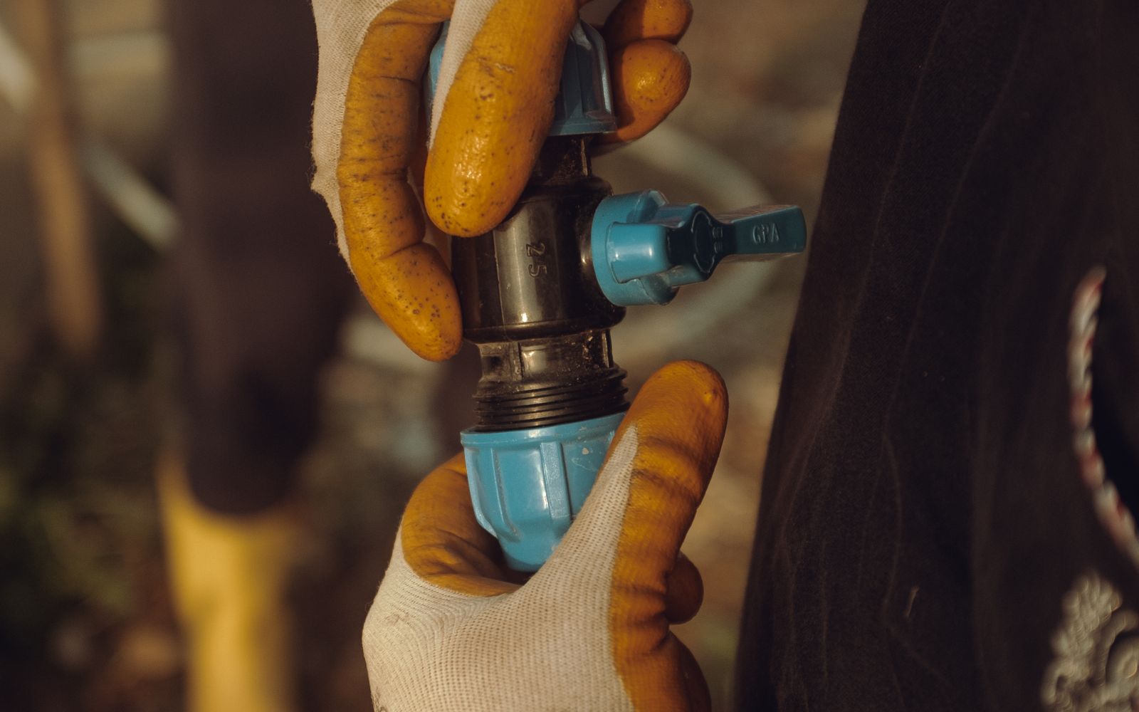 Plumber repairing a leaking pipe joint